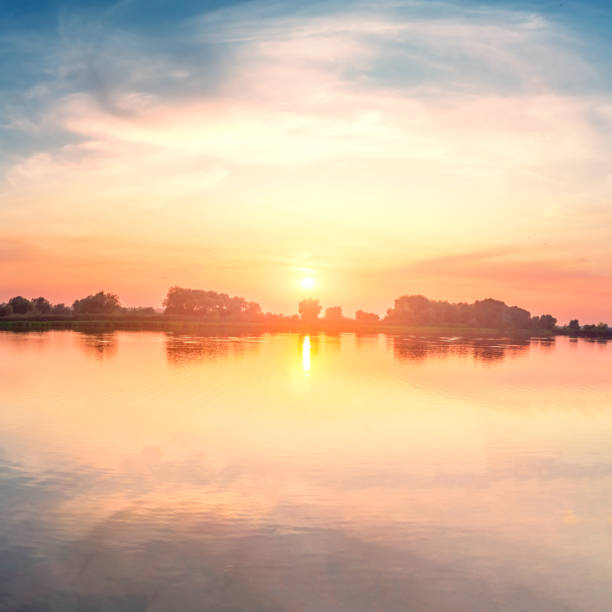 istock Beautiful sunset, sky with clouds above lake. 1213703119