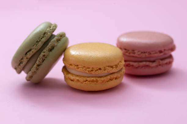 istock delicious colorful macaroons on pink paper background 1213703273