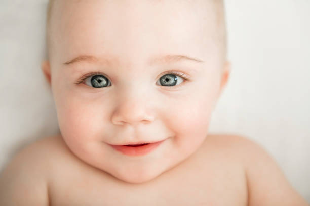istock cute baby boy lying on a white bed 1213704006