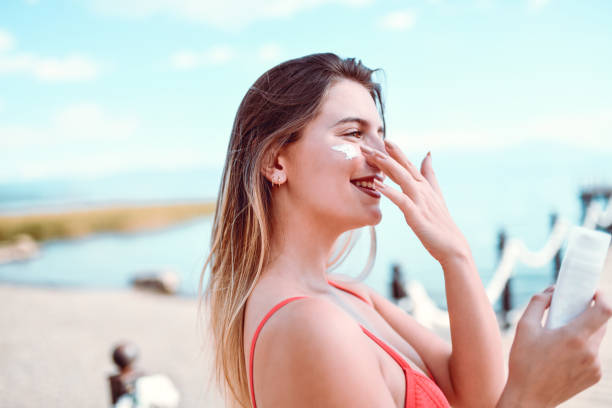 istock Female Putting Sunscreen on Face 1213704682