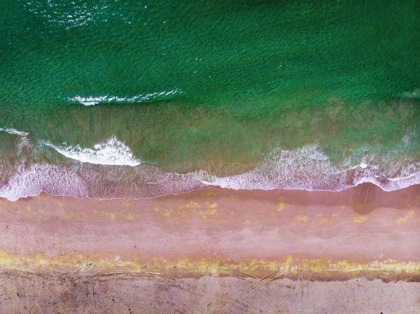 Waves splashing the sea shore aerial footage