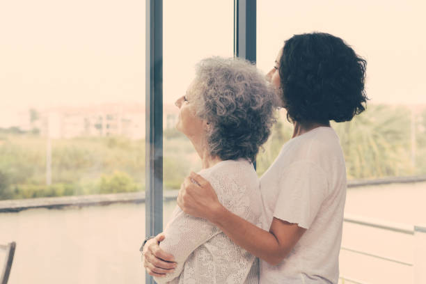 istock Peaceful middle aged and senior women watching scene from window 1213705772