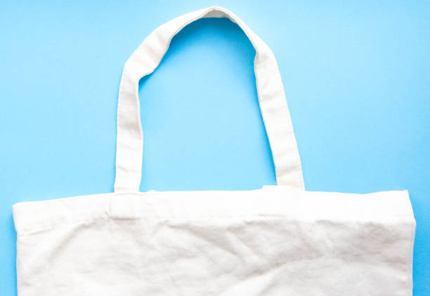 istock Eco bag on a blue, yellow, pink background. Eco-friendly bag in macro.  Copy Space 1213707345