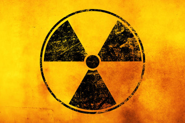 istock Black radioactive sign over yellow background 1213708094