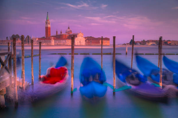 Long exposure: blurred ethereal Gondolas at sunset - San Giorgio, Venice, Italy Long exposure: blurred ethereal Gondolas at sunset - San Giorgio, Venice, Italy venice italy grand canal honeymoon gondola stock pictures, royalty-free photos & images