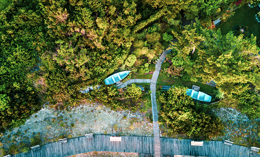 Two parked boats in the garden by the beach aerial view