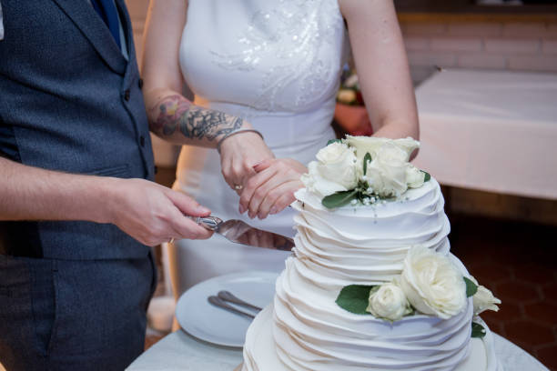 istock newlyweds cut a wedding cake 1213712290