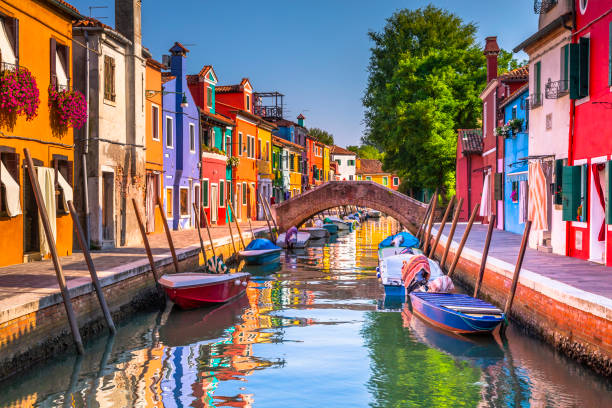 boats on water canal in colorful burano island - venice, italy - house residential structure multi colored burano imagens e fotografias de stock
