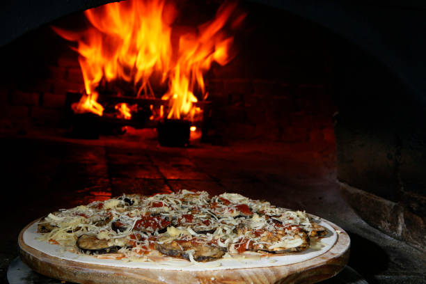 istock Italian pizza on woodfired stone oven 1213714310
