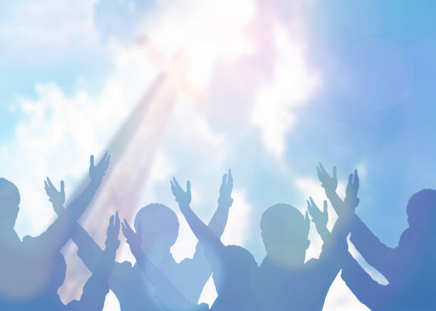 Christian Praise and Worship soft focus of Christian people group raise hands up worship God Jesus Christ together in church revival meeting with an image of wooden cross over cloudy sky can be used for Christian worship background sing praise stock pictures, royalty-free photos & images