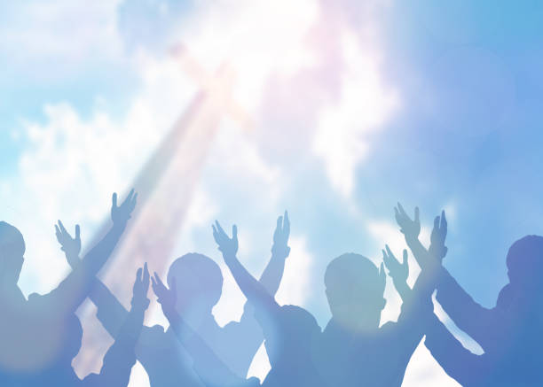 Christian Praise and Worship soft focus of Christian people group raise hands up worship God Jesus Christ together in church revival meeting with an image of wooden cross over cloudy sky can be used for Christian worship background revival stock pictures, royalty-free photos & images