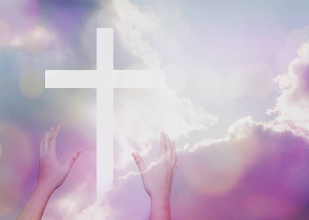 istock worship hands over a white cross on pastel color sky 1213715801