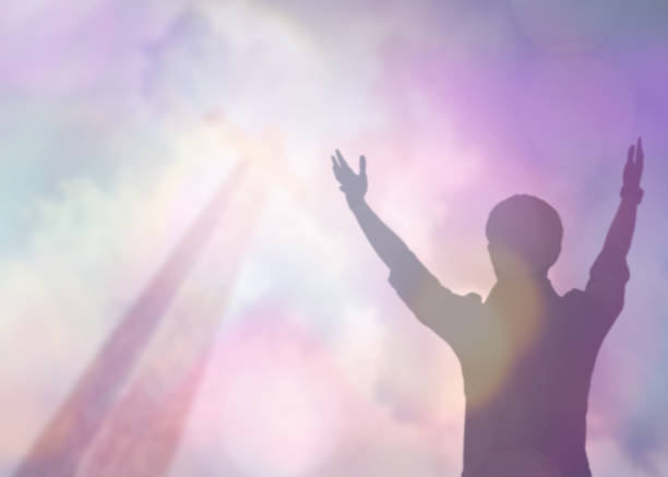 Silhouettes of man raise hand up worship God over the cross in cloudy sky soft focus and Silhouettes of man raise hand up worship God over the cross in cloudy sky . Christian background with copy space for your text revival stock pictures, royalty-free photos & images