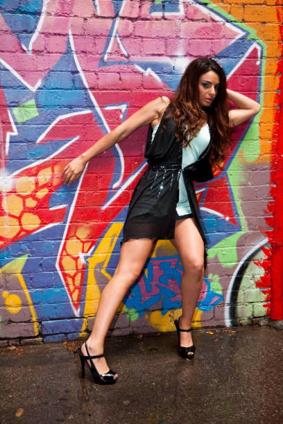 istock Young Woman and a Wall With Graffiti 121371598