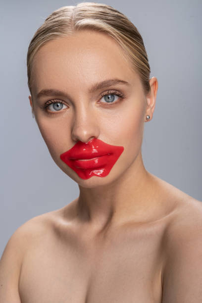 istock Tender young female doing patches on lips 1213717561