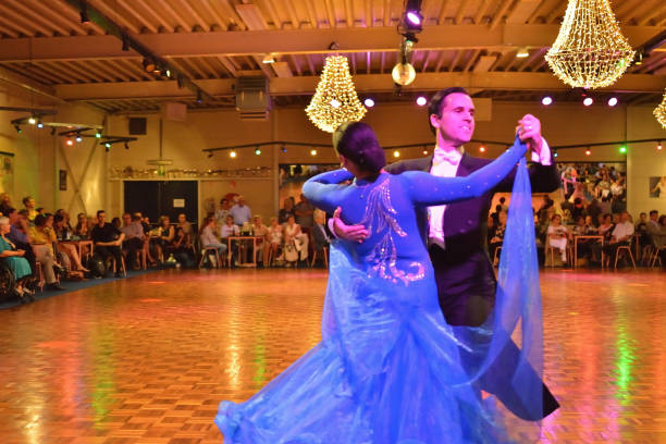 Herent, Belgium - September 14, 2019: Open House indoor dancing classes evening show. Standard competition Dancers  demonstration.Lady ultramarine blue show dress.