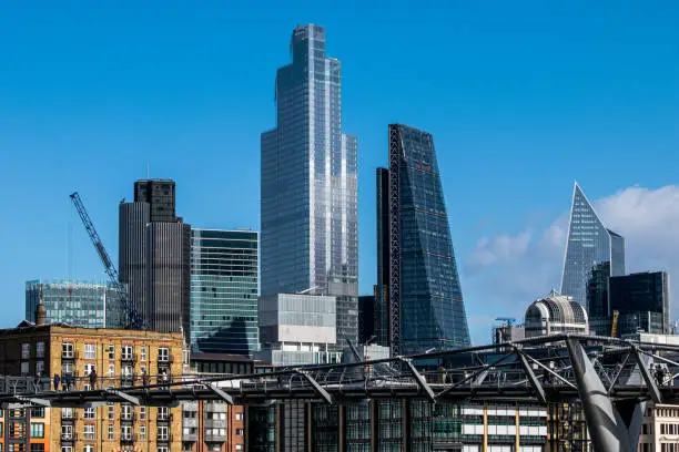 Photo of The City of London behind the Millennium Bridge