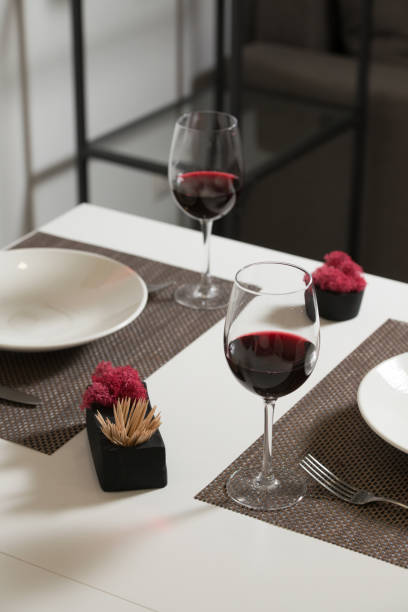 Glassware and cutlery for catered event dinner.