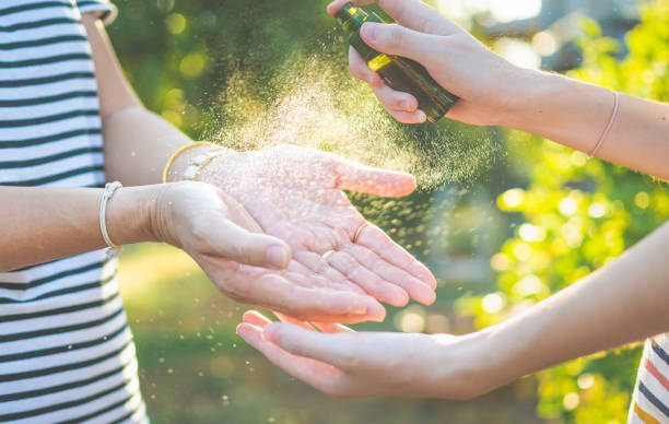 istock Asian people wearing protect mask and spray disinfectant alcohol on hand to prevent  spreading of the coronavirus ( Covid-19) 1213719829