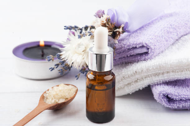 istock Essential oil and lit lavander candle 1213720592