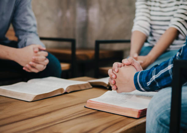 istock group of christian  sitting around wooden table 1213722818