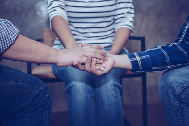 istock Christian people joining hands and prays together 1213722890