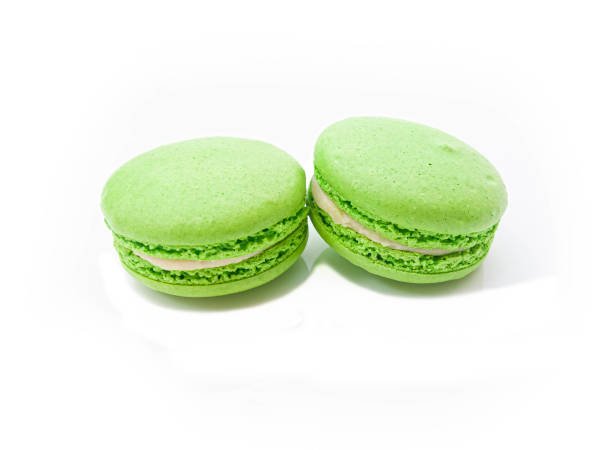 istock two bright green macaroons on a white isolated background 1213727436