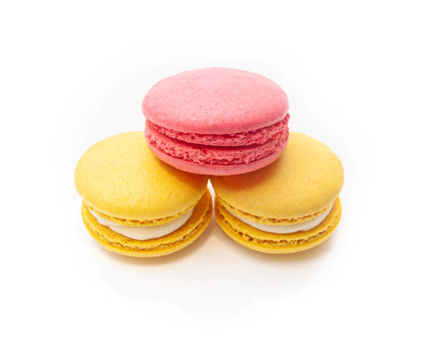 istock three pyramid shaped macaroons one pink and two yellow on a white isolated background 1213727447
