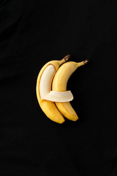istock Two bananas lie side by side and hug each other like people. 1213727458