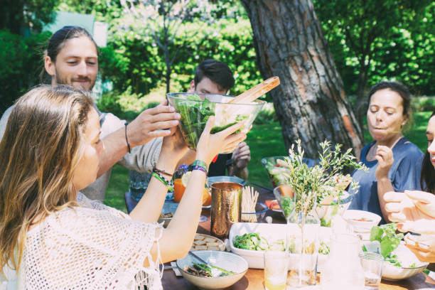 istock Cheerful young people at table in yard 1213728318