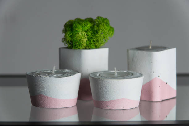 istock candles and moss in white and pink concrete candle holders 1213728328