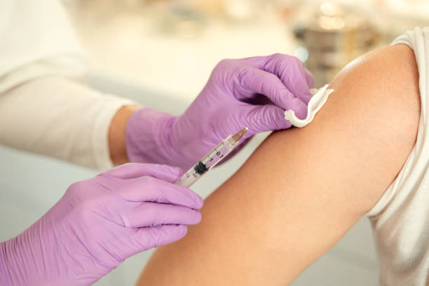 istock Doctor applying vaccine to patient 1213728606