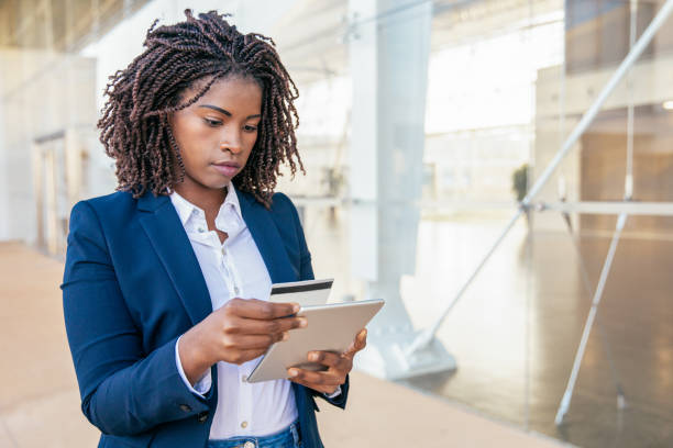 istock Serious focused office employee paying online 1213728904
