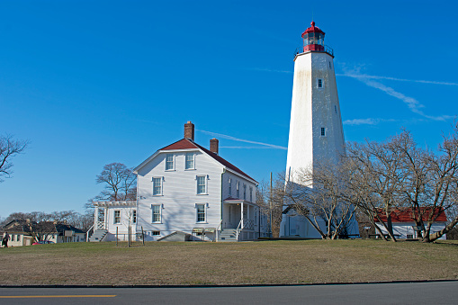 Lighthouse in Sandy Hook, New Jersey, during daylight hours, with the light turned off