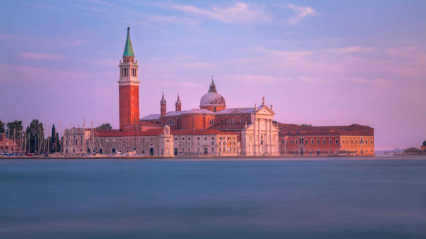 Long exposure: blurred ethereal San Giorgio Maggiore cathedral at sunset - Venice, Italy Long exposure: blurred ethereal San Giorgio Maggiore cathedral at sunset - Venice, Italy venice italy grand canal honeymoon gondola stock pictures, royalty-free photos & images