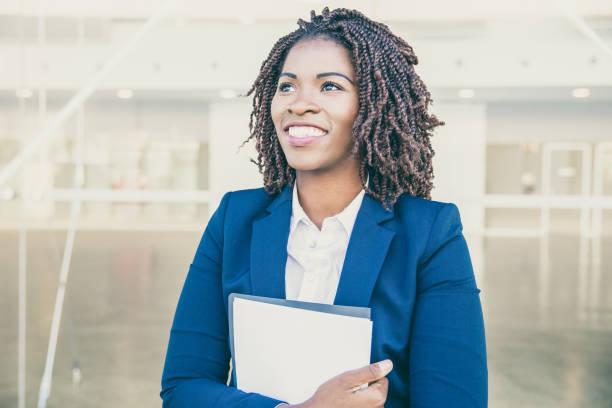 istock Happy excited professional with documents walking outside 1213729863