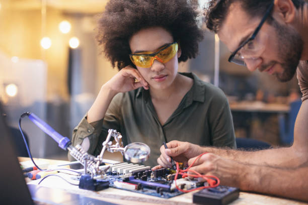 istock Co-workers working late on a circuit boards in office 1213731969