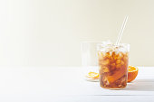 Cold brew coffee mocktail with orange peel and glass straw