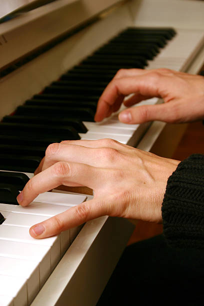 istock Close up of hands on piano 121373395