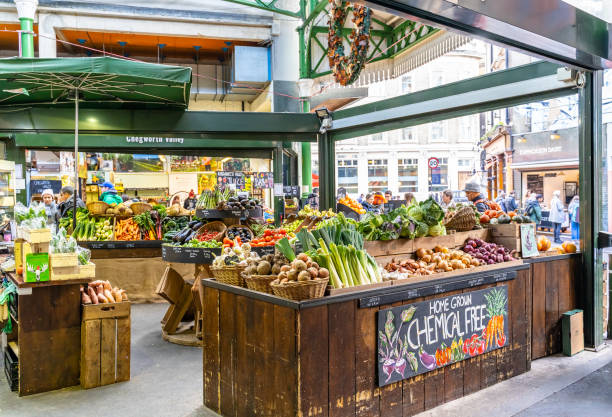 Market stall at Borough Market, London, UK This pic shows Market stall selling fresh fruit and vegetables at Borough Market, London, UK. Some people can be seen in the pic. borough market stock pictures, royalty-free photos & images