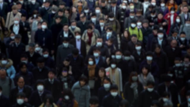 4K, Blurred defocused view people wearing protective mask as protection flu