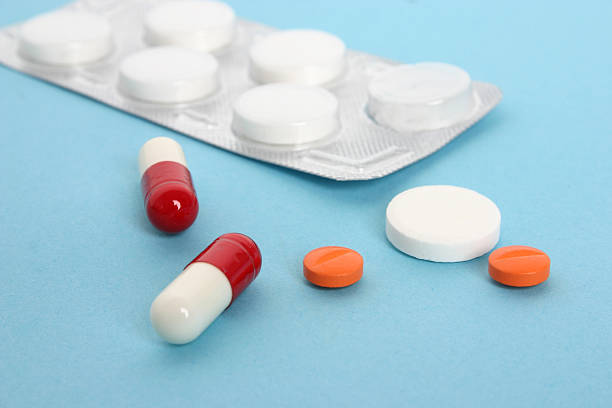 istock medicine pills and pill packaging on blue 121373785