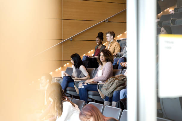 istock Group of college students wait for class to begin 1213739008