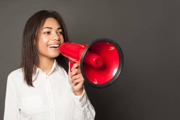 istock African American woman with loudspeaker 1213739404