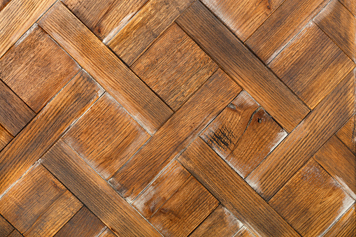 A beautiful panel of old oak rectangular wooden planks with a neatly laid out rhombus pattern. Texture and background of old wood.