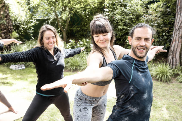 istock Trainer helping man in yoga practice 1213739601