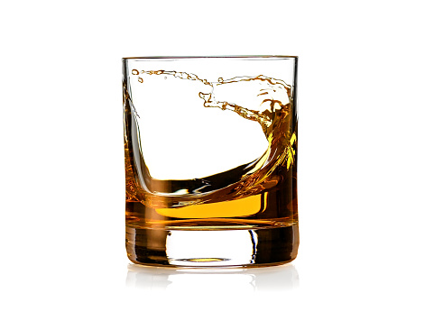Glass of Whiskey with splash isolated on white background