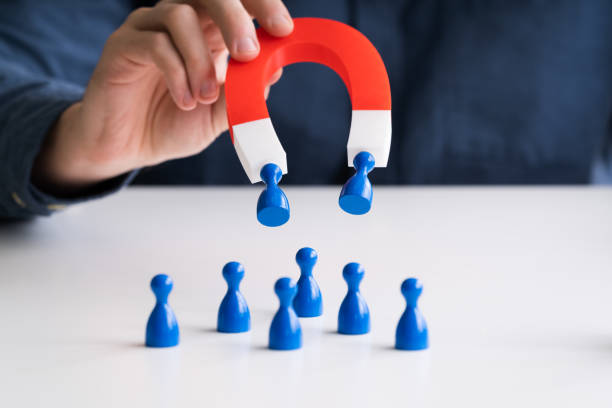 istock Businessperson Attracting Human Figures With Horseshoe Magnet 1213740830