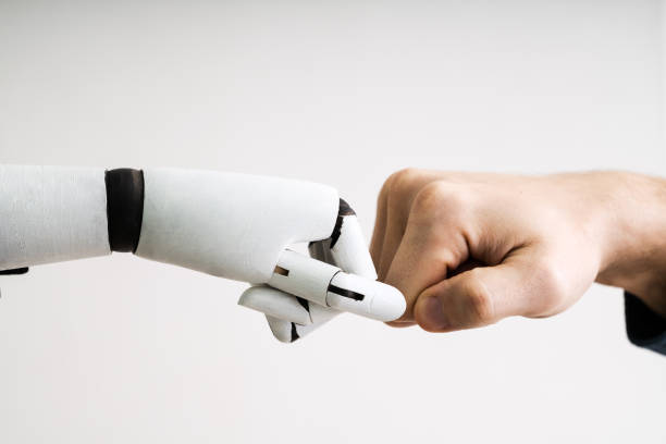 istock Robot And Human Hand Making Fist Bump 1213740865