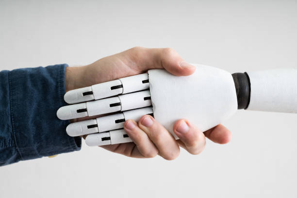 istock Businessperson And Robot Shaking Hands 1213740879